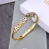 J'Adior Hinge Bangle Metal with J'Adior Signature and Elephant Charm Embellished Crystals Gold